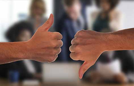 two hands thumbs up and down