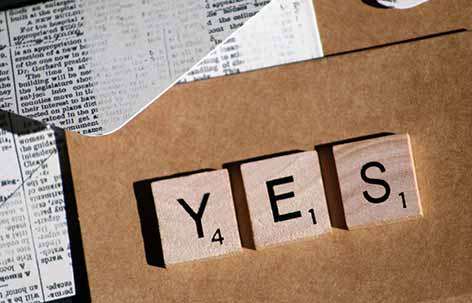word yes made from wooden scrabble letters