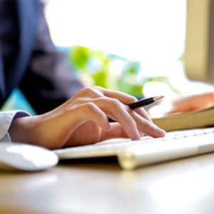 a person searching on web and taking notes