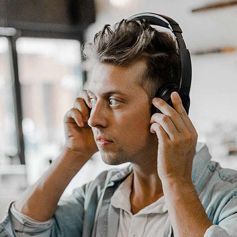 ielts listening test, man listening with headphones